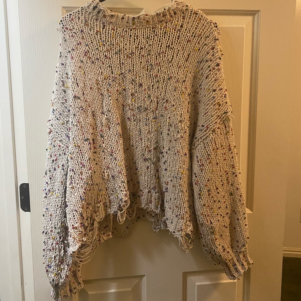 Urban Outfitters pompom distressed sweater
